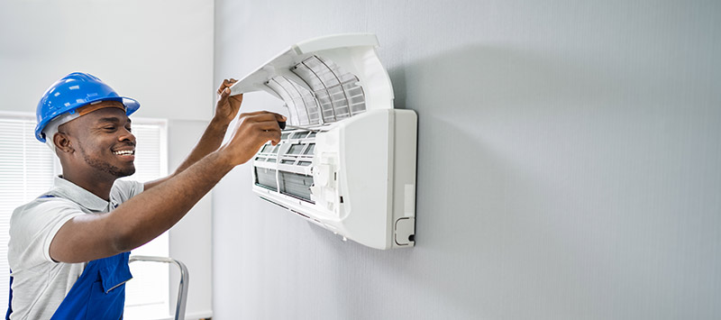 Man smiles at air conditioning unit