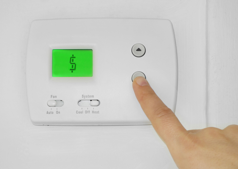 Thermostat with a dollar symbol on the screen.