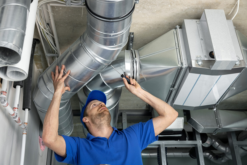 an HVAC tech checking on noisy air ducts.